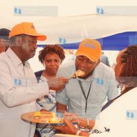 Azimio leader Raila Odinga feeds a guest cake