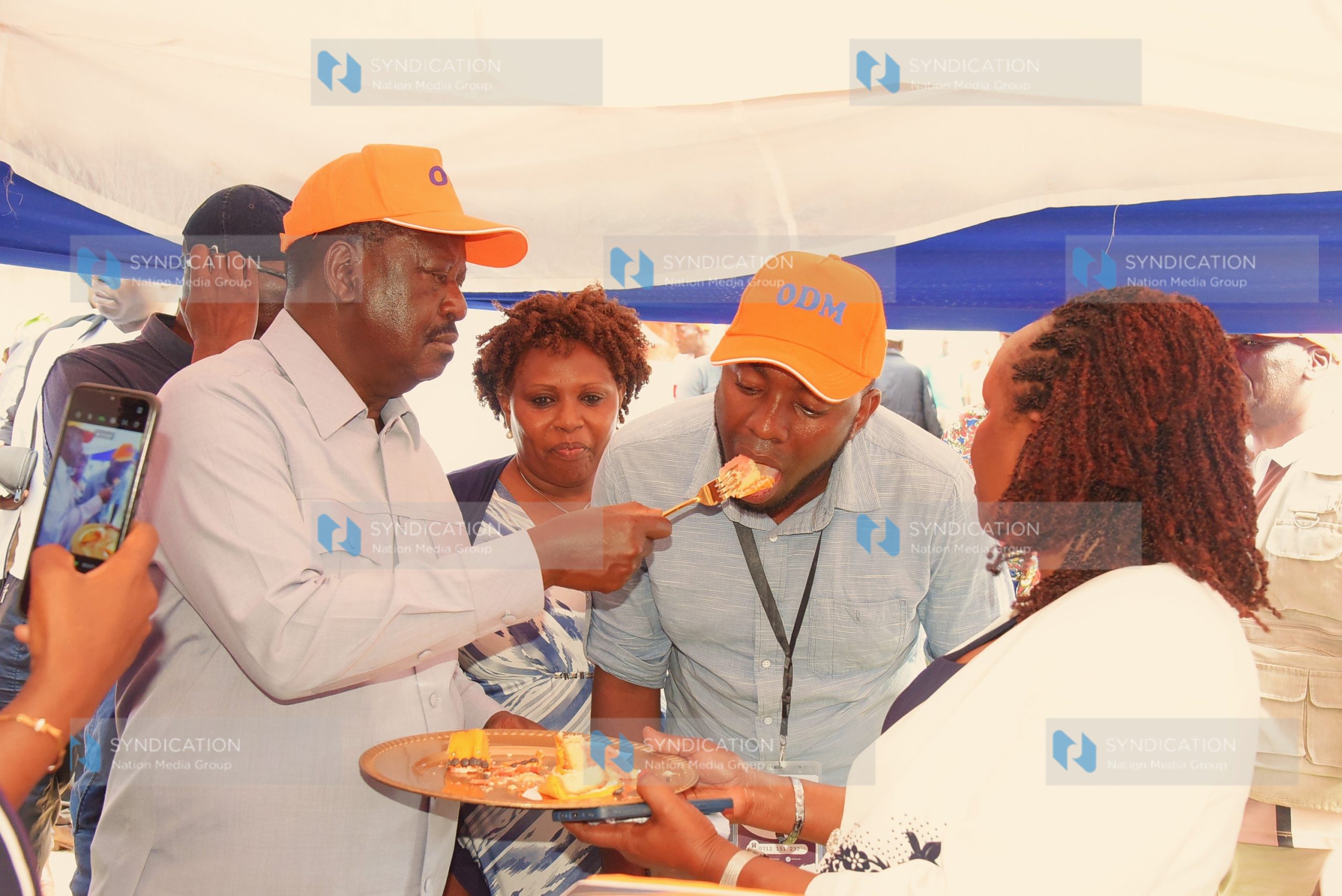 Azimio leader Raila Odinga feeds a guest cake