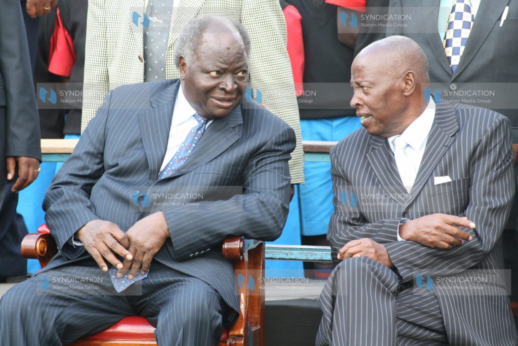 President Mwai Kibaki talks to one of the co- founders of the Starehe Boys center, Joseph Gikubu