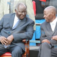 President Mwai Kibaki talks to one of the co- founders of the Starehe Boys center, Joseph Gikubu