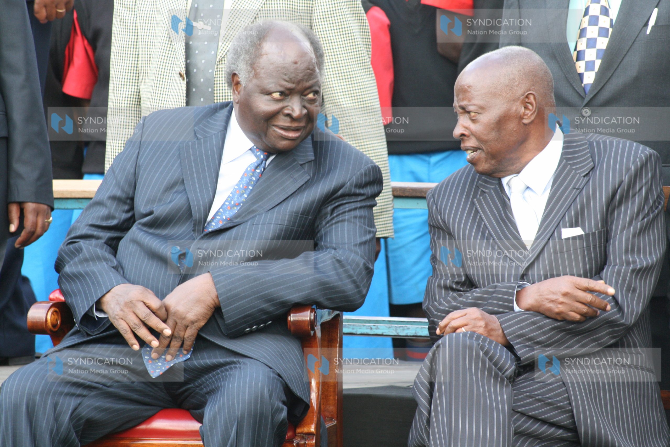 President Mwai Kibaki talks to one of the co- founders of the Starehe Boys center, Joseph Gikubu