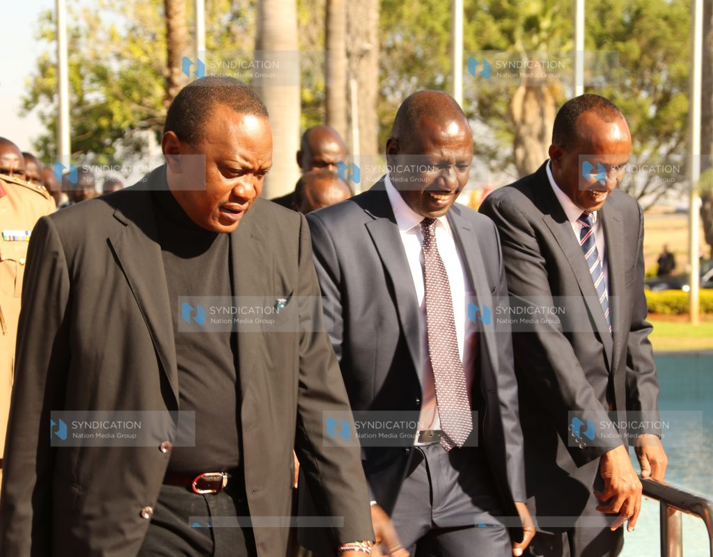 President Uhuru Kenyatta chats with Deputy President William Ruto and National Assembly Majority Leader Aden Duale