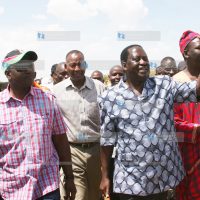 Prime Minister Raila Odinga (right) acknowledges greetings from residents of Isinya town