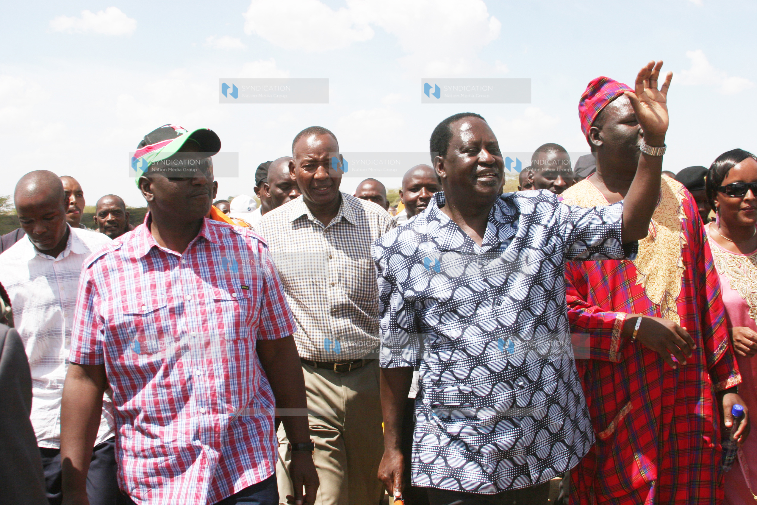 Prime Minister Raila Odinga (right) acknowledges greetings from residents of Isinya town