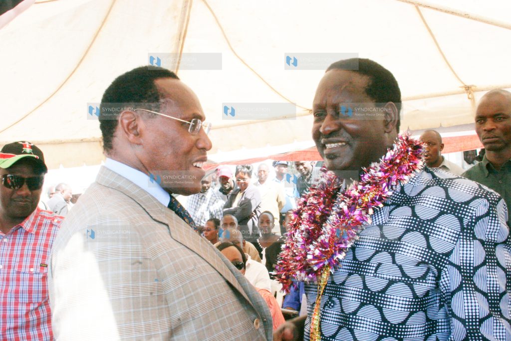 Prime Minister Raila Odinga (right) chats with the Internal Security Minister