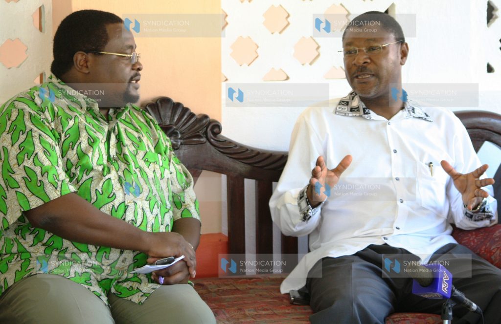 Foreign Affairs Minister Moses Wetangula chats with the general manager of Sun ‘N’ Sand Beach Resort, Andimile Makumbi