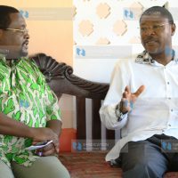 Foreign Affairs Minister Moses Wetangula chats with the general manager of Sun ‘N’ Sand Beach Resort, Andimile Makumbi
