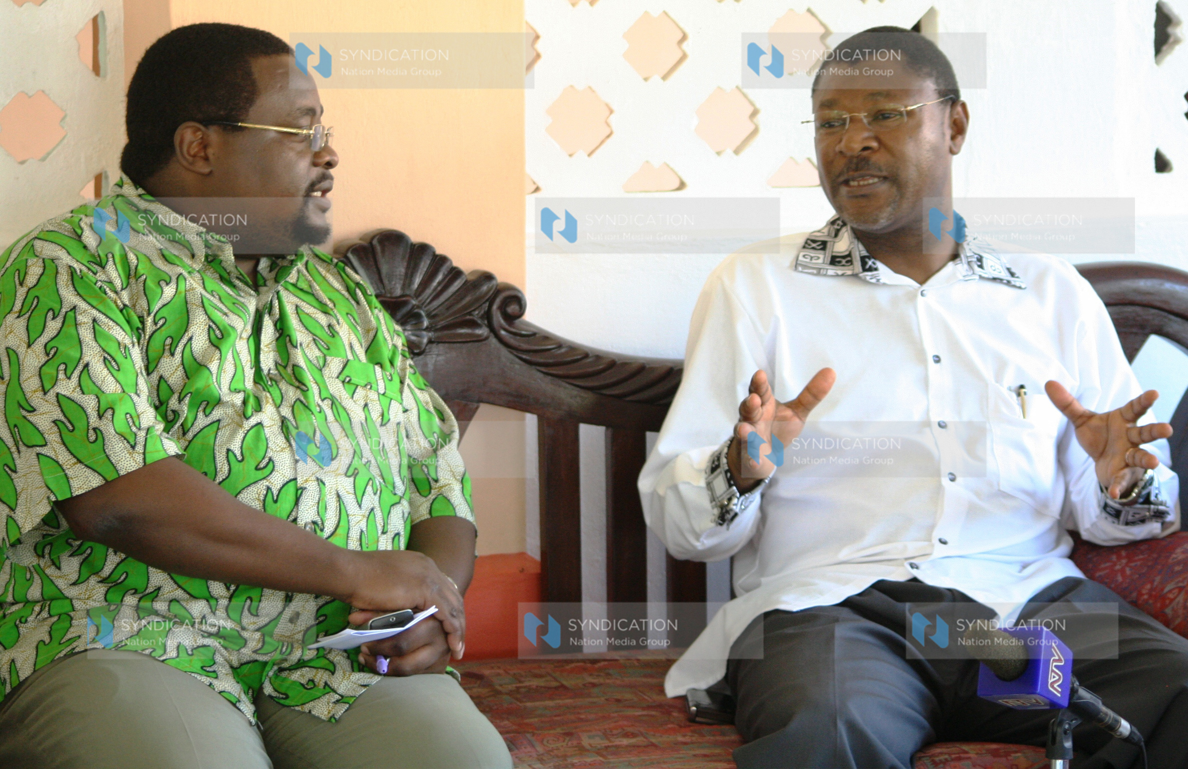 Foreign Affairs Minister Moses Wetangula chats with the general manager of Sun ‘N’ Sand Beach Resort, Andimile Makumbi