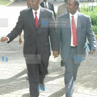 Kenya's Finance Minister Amos Kimunya is escorted by the governor of the CBK Professor Ndung'u Njuguna