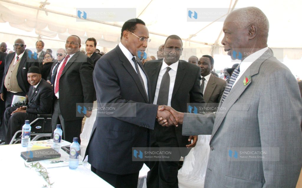 Former President Daniel Arap Moi shakes hands with Internal Security Minister Prof George Saitoti