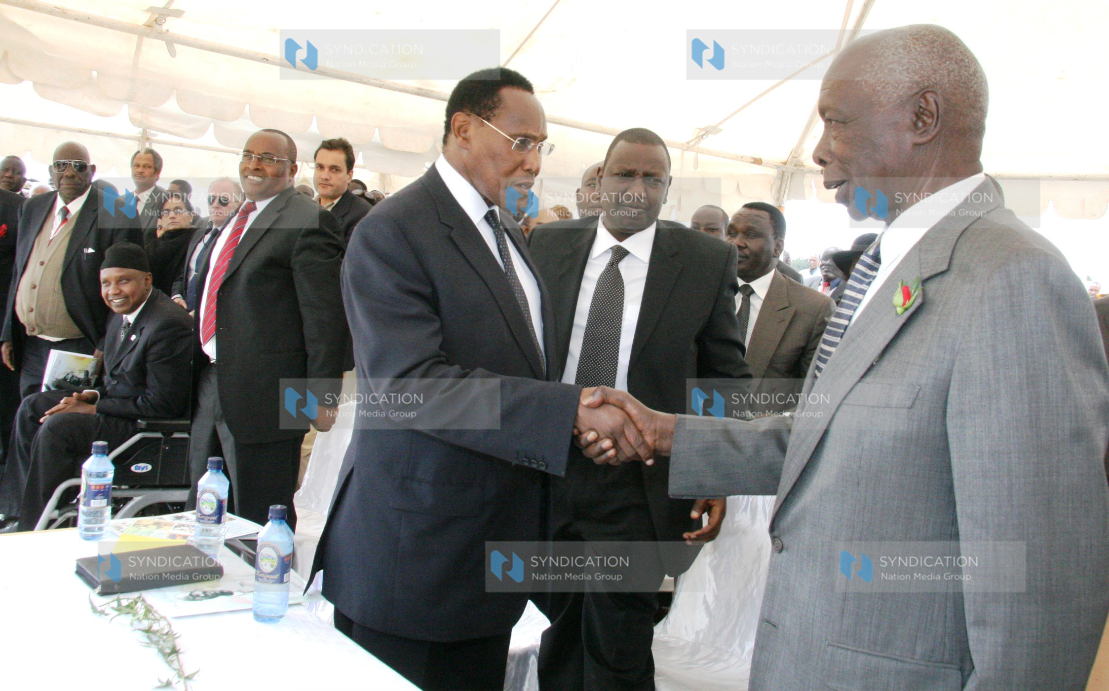 Former President Daniel Arap Moi shakes hands with Internal Security Minister Prof George Saitoti