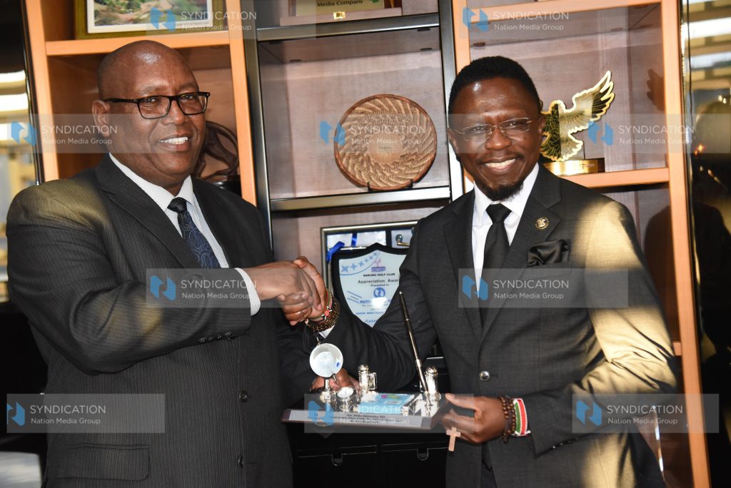 Ababu Namwamba (right) receiving a token of appreciation from Stephen Gitagama