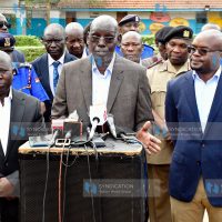 Principal Secretary for the State Department for Basic Education Belio Kipsang (center) briefs the media