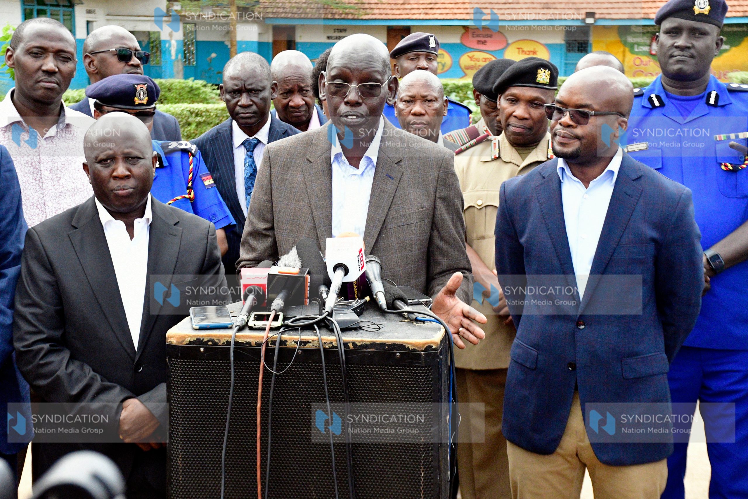 Principal Secretary for the State Department for Basic Education Belio Kipsang (center) briefs the media