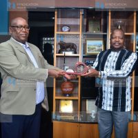 NMG Chief Executive Officer Stephen Gitagama presents a gift to Health Cabinet Secretary Mutahi Kagwe
