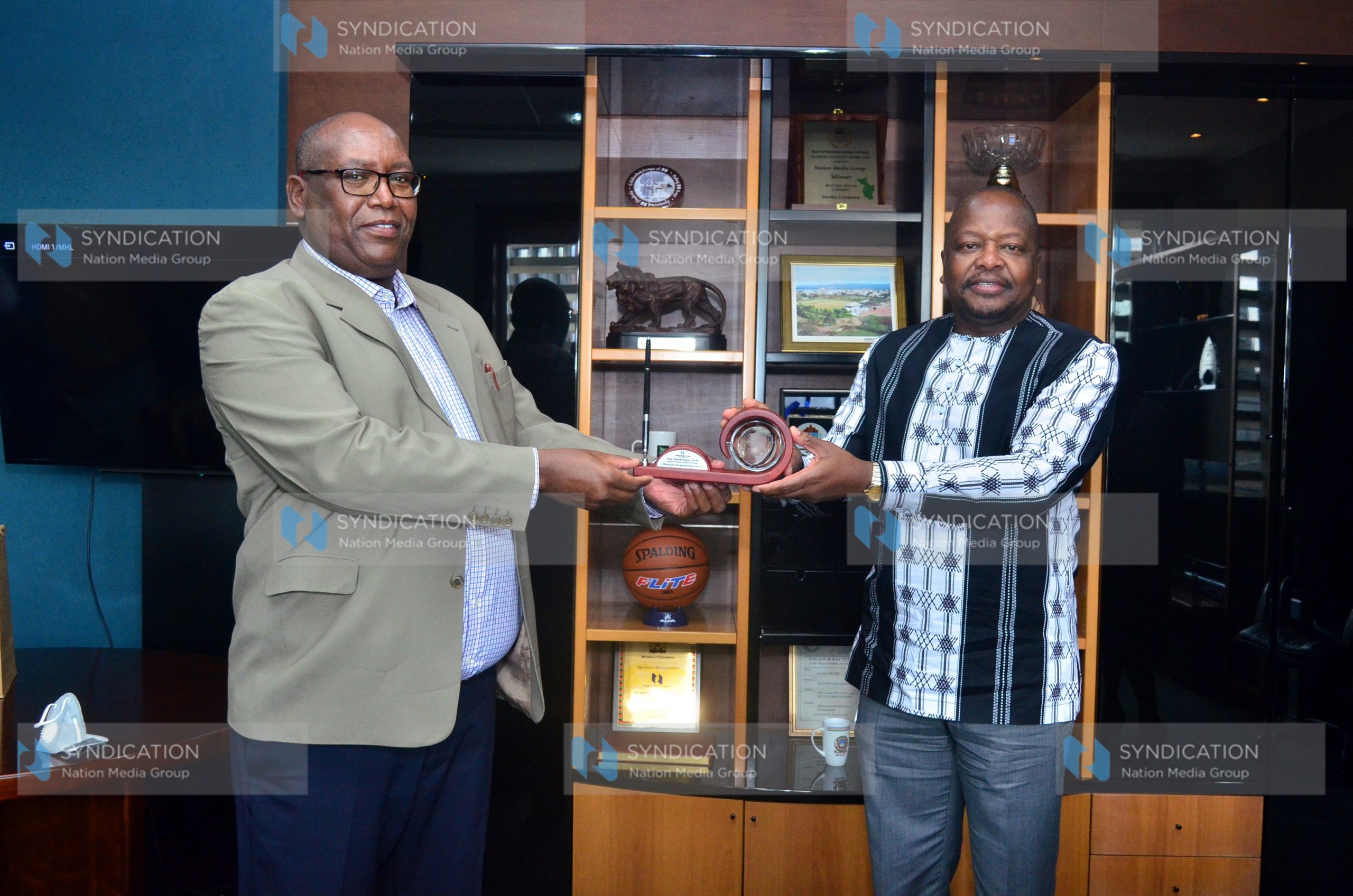 NMG Chief Executive Officer Stephen Gitagama presents a gift to Health Cabinet Secretary Mutahi Kagwe