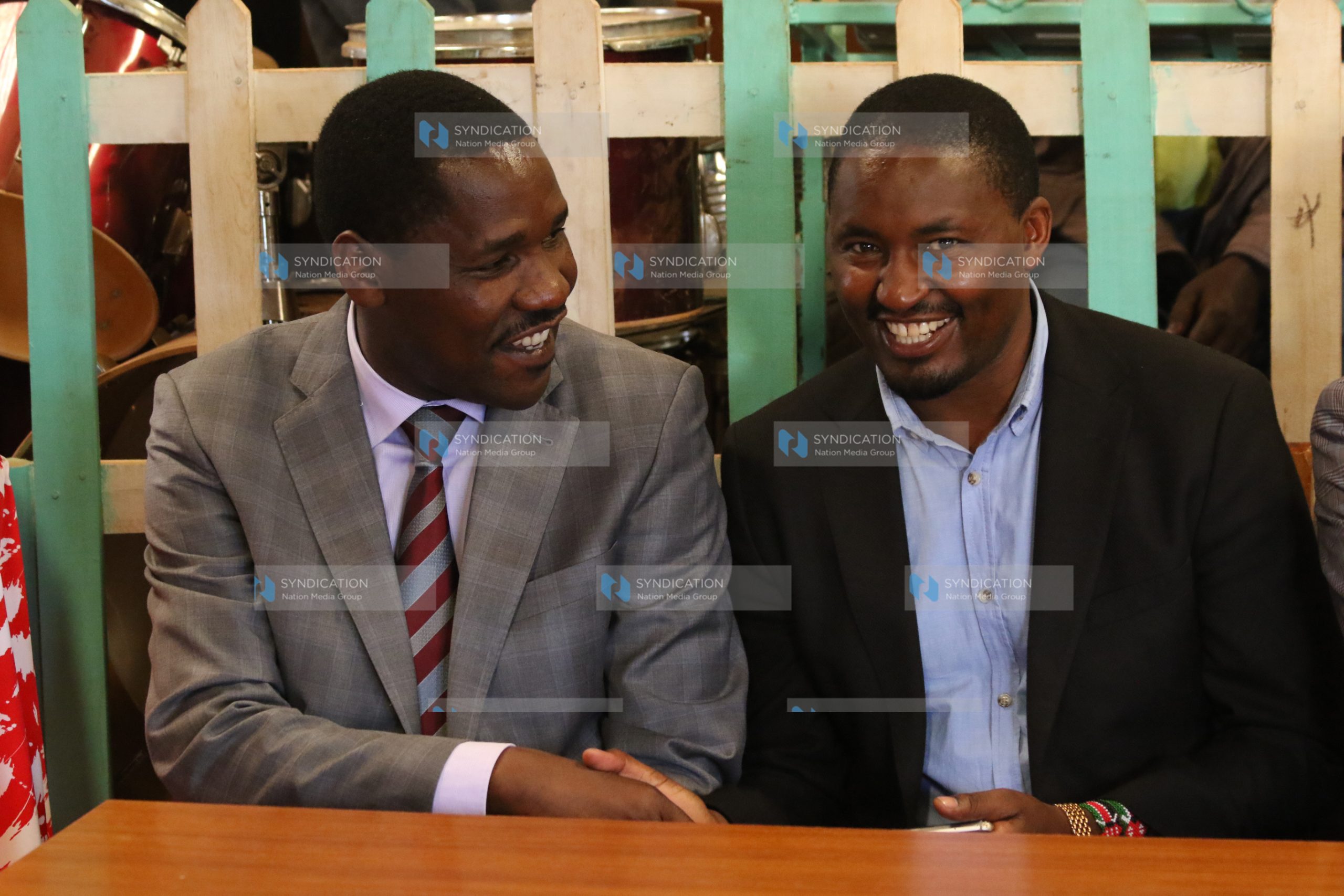 Mwangi Kiunjuri (right) shakes hands with Meru Governor Peter Munya
