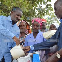 Mwangi Kiunjuri and his Transport counterpart James Macharia distribute relief food