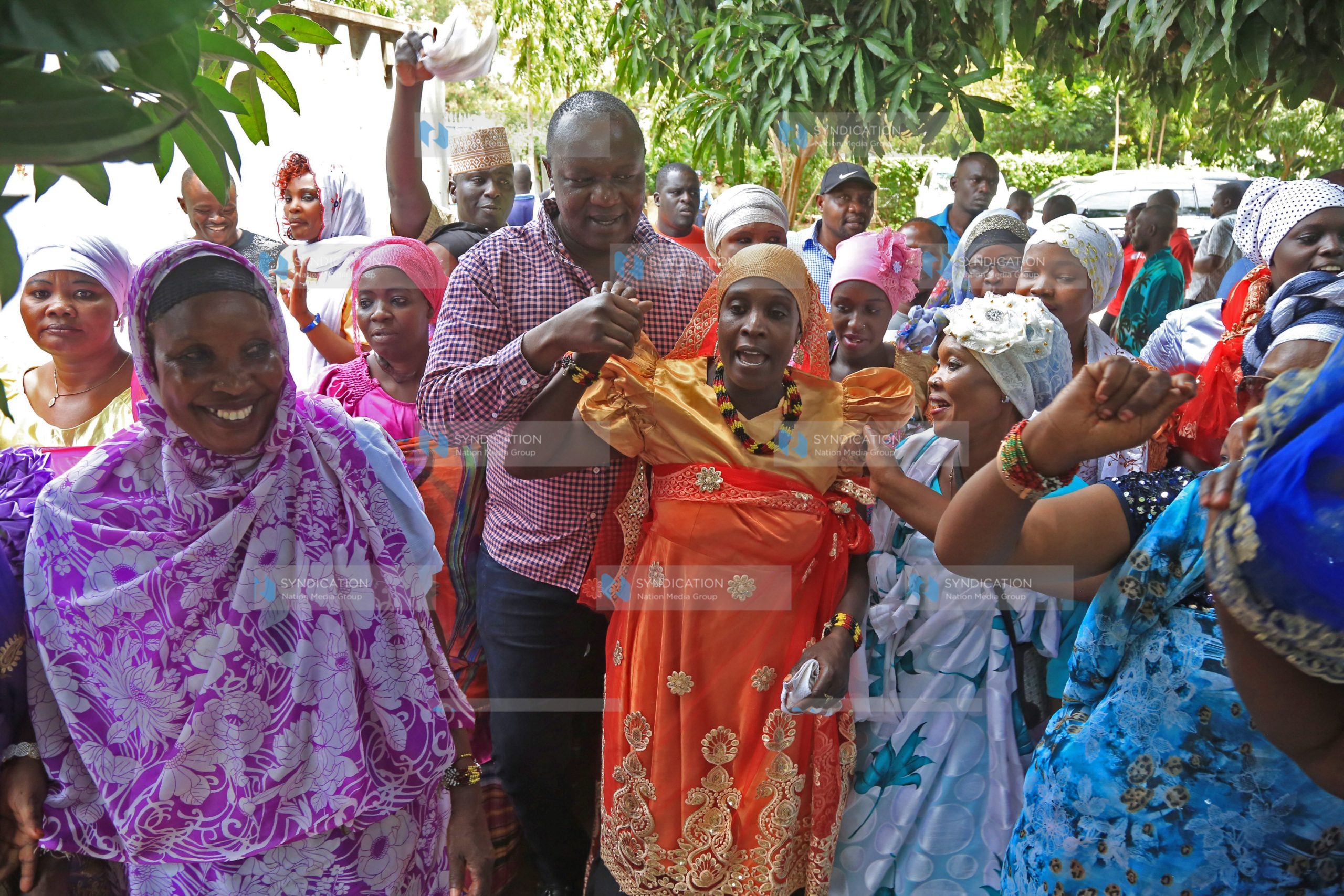 Kisumu Senator Tom Ojienda (C) joins in a dance with the Nubian community members