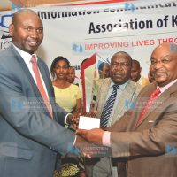 Prof. Chegge Mungai, Deputy Vice-Chancellor, Student Welfare, Alumni and Marketing Affairs, Mount Kenya University, receives the overall ICT Value Award from Amb. Prof. Julius Bitok