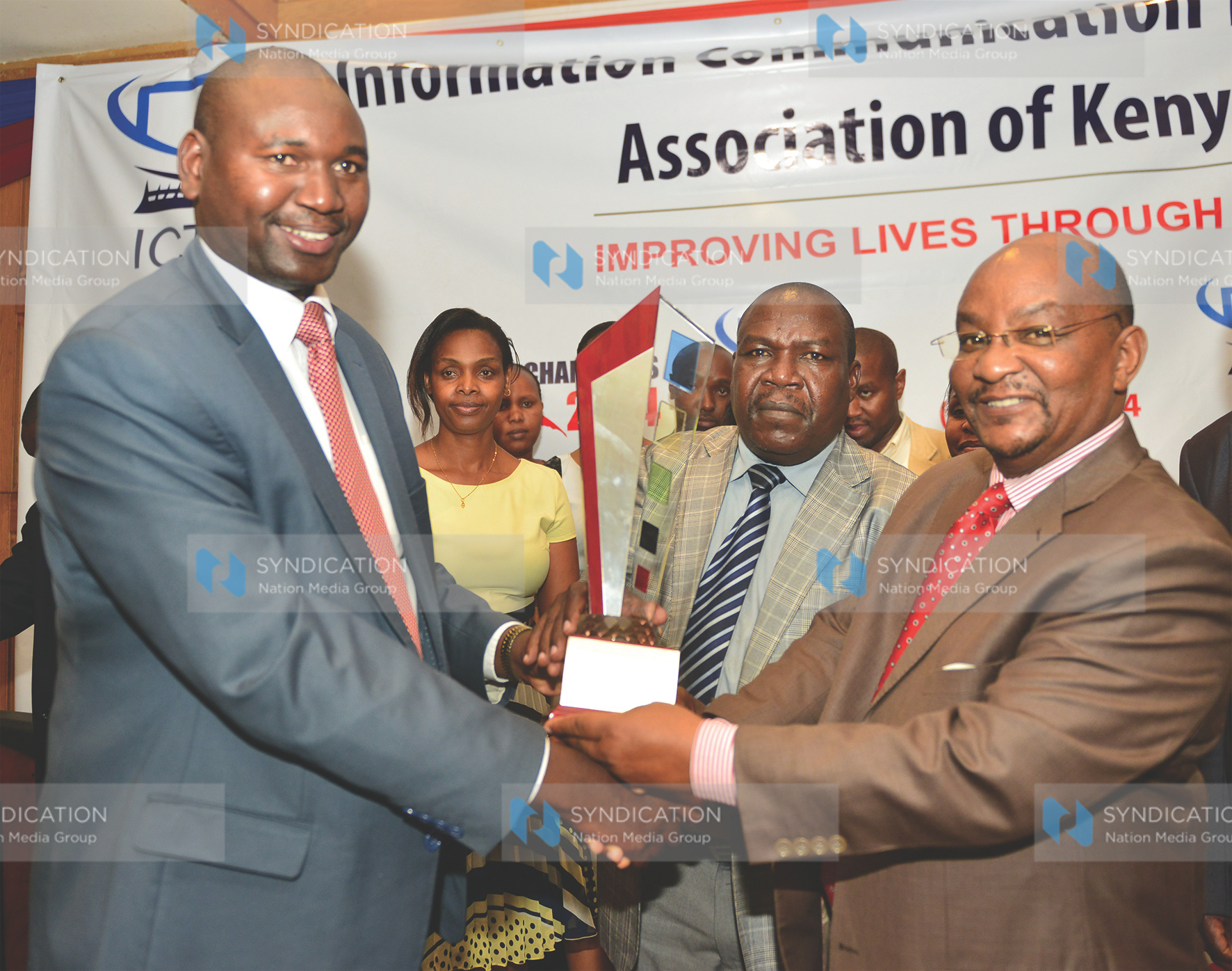 Prof. Chegge Mungai, Deputy Vice-Chancellor, Student Welfare, Alumni and Marketing Affairs, Mount Kenya University, receives the overall ICT Value Award from Amb. Prof. Julius Bitok