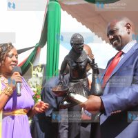 Murang'a county women representative Sabina Chege, presents a sculpture gift to Deputy President William Ruto