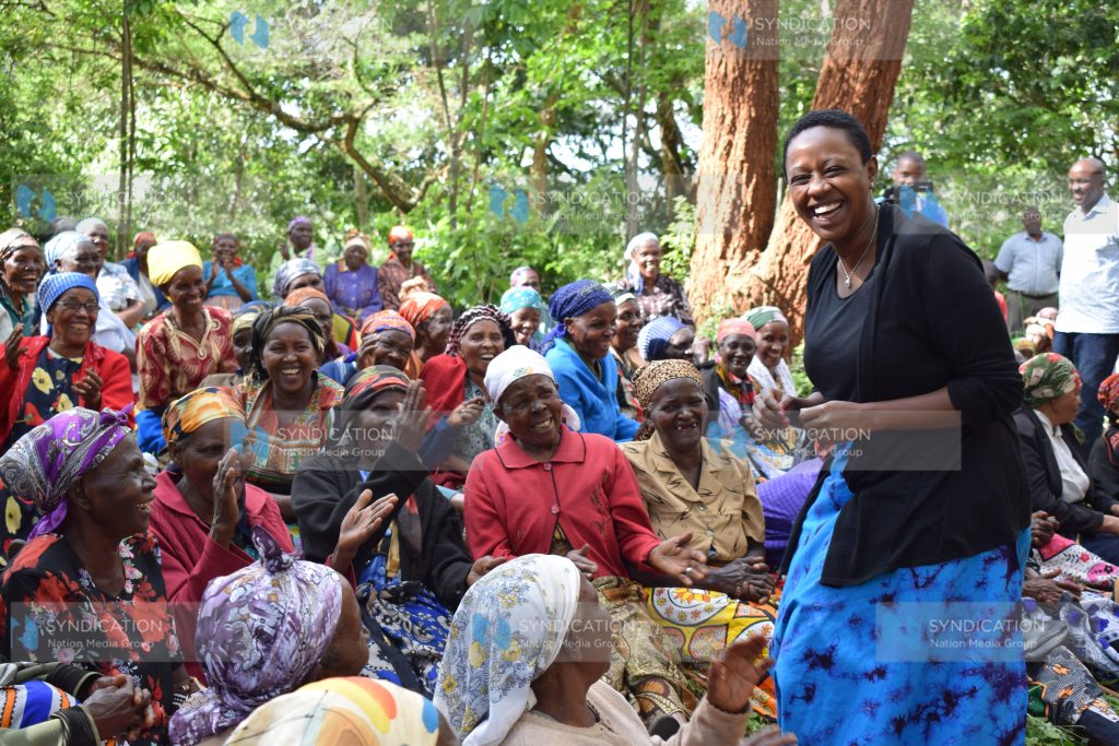 Murang'a Woman Rep Sabina Chege shares a light moment with elderly women