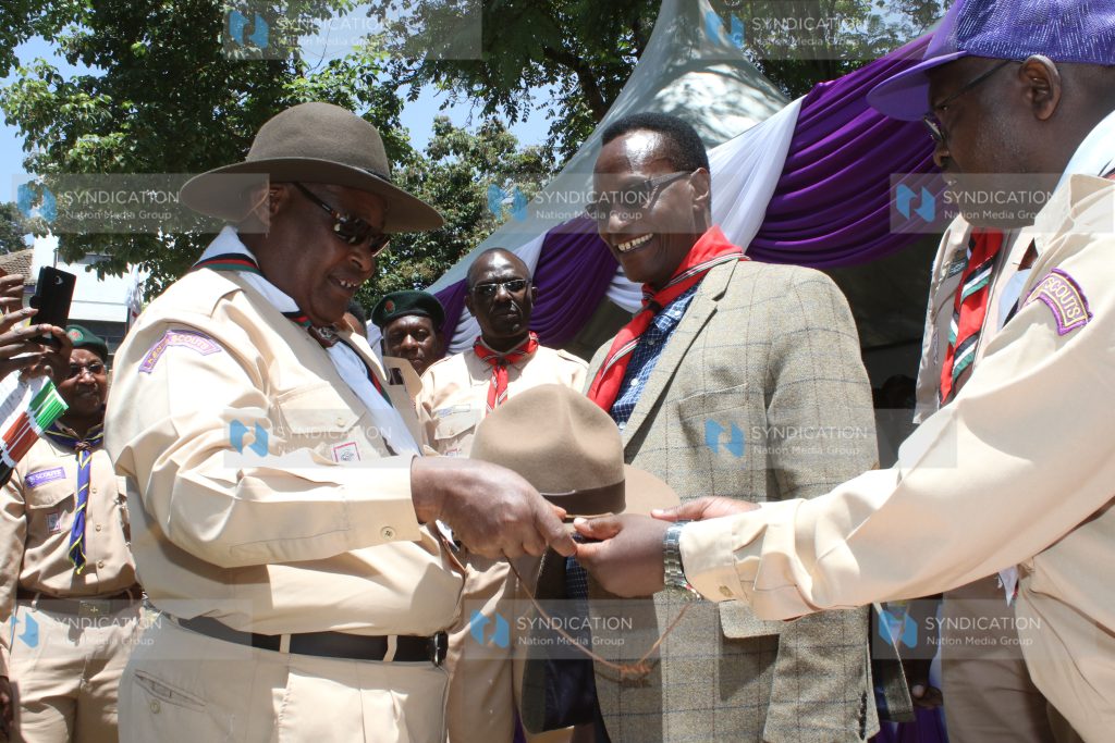Chief Scout Francis Ole Kaparo, presents a hat to Lands CS Jacob Kaimenyi