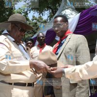 Chief Scout Francis Ole Kaparo, presents a hat to Lands CS Jacob Kaimenyi