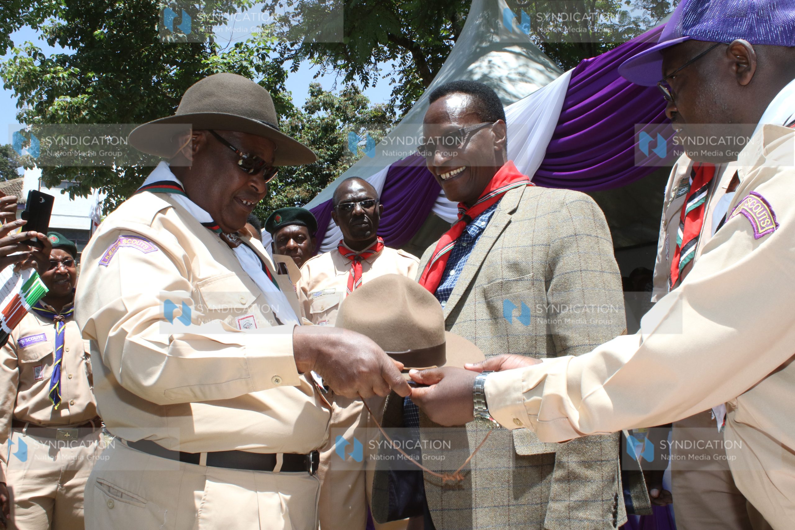 Chief Scout Francis Ole Kaparo, presents a hat to Lands CS Jacob Kaimenyi