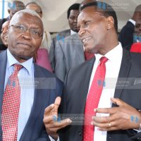 Education Cabinet Secretary Jacob Kaimenyi chatting with CRA commissioner Raphael Munavu