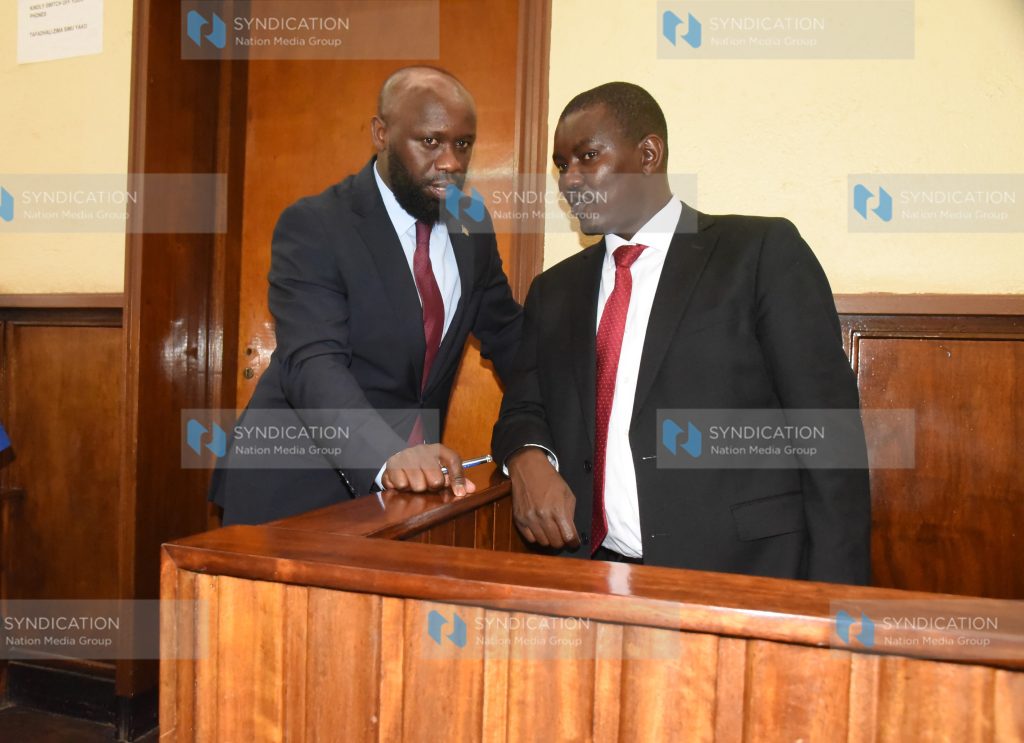 Uasin Gishu Senator Jackson Mandago chats with his lawyer Stephen Kibungei