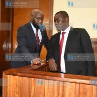 Uasin Gishu Senator Jackson Mandago chats with his lawyer Stephen Kibungei