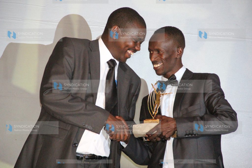 Ezekiel Kemboi, receives the World Championships Gold Award from Uasin Gishu County Governor Jackson Mandago