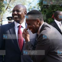 Deputy President William Ruto shares a joke with Education Cabinet Secretary Jacob Kaimenyi