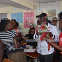Jubilee deputy leader William Ruto presents flowers to students of Buruburu College