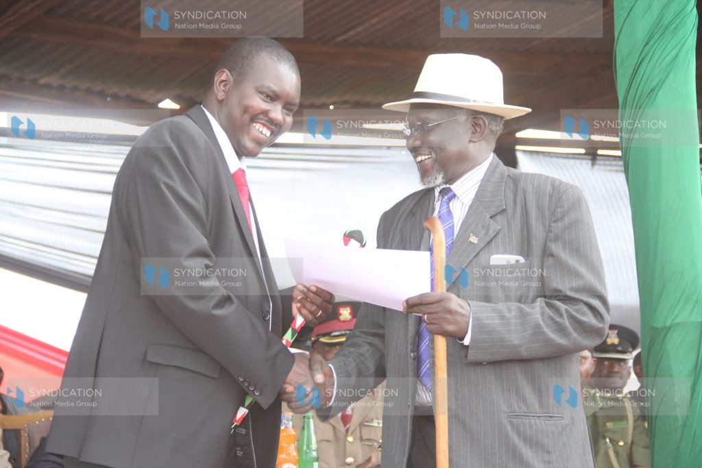 Uasin Gishu County Governor Jackson Mandago receives a certificate from Retired Major John Seii