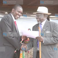 Uasin Gishu County Governor Jackson Mandago receives a certificate from Retired Major John Seii