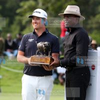 Cabinet Secretary Youth Affairs, Creative Economy and Sports Ababu Namwamba hands over the DP World Tour Magical Kenya Open Golf Trophy to winner Van Driel Darius
