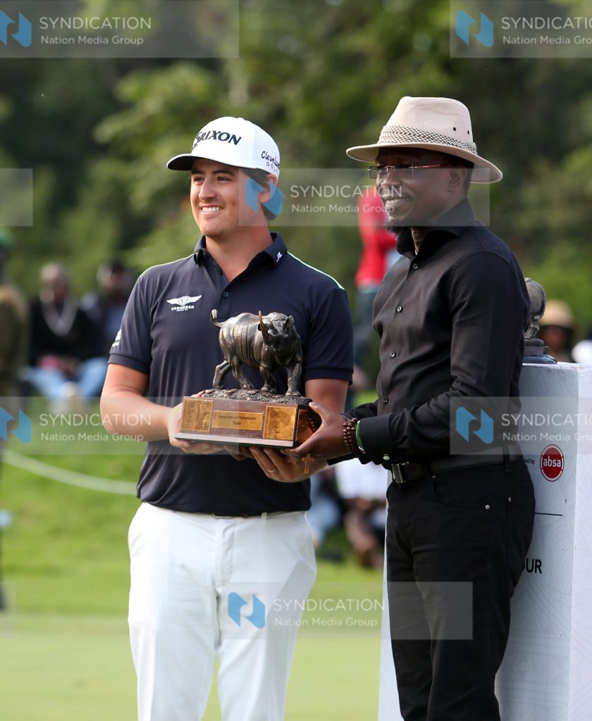 Cabinet Secretary Youth Affairs, Creative Economy and Sports Ababu Namwamba hands over the DP World Tour Magical Kenya Open Golf Trophy to winner Van Driel Darius