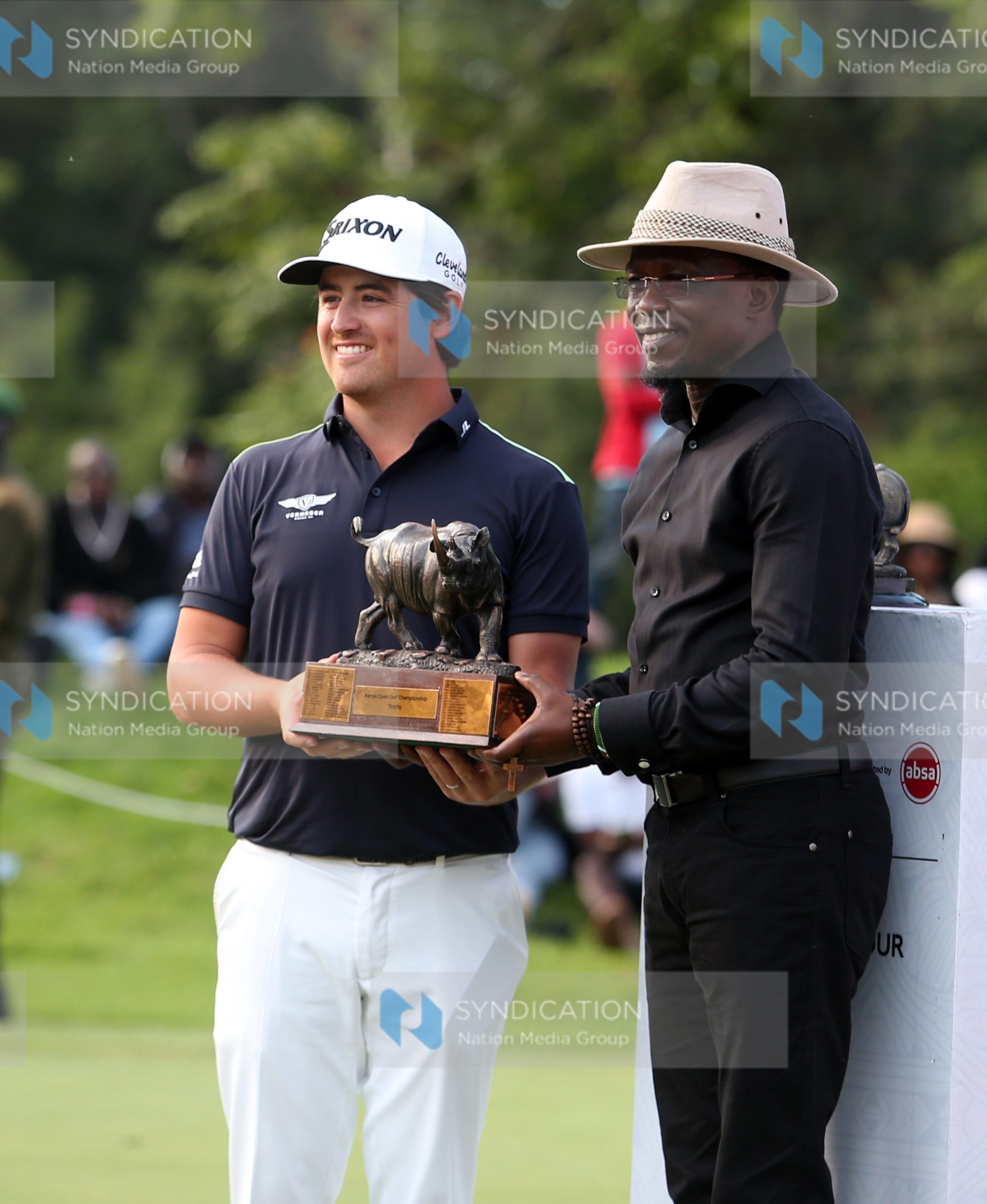 Cabinet Secretary Youth Affairs, Creative Economy and Sports Ababu Namwamba hands over the DP World Tour Magical Kenya Open Golf Trophy to winner Van Driel Darius