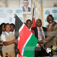 Principle Secretary Education Belio Kipsang hands over National Flag to Kenya Team Sheila Mugweru