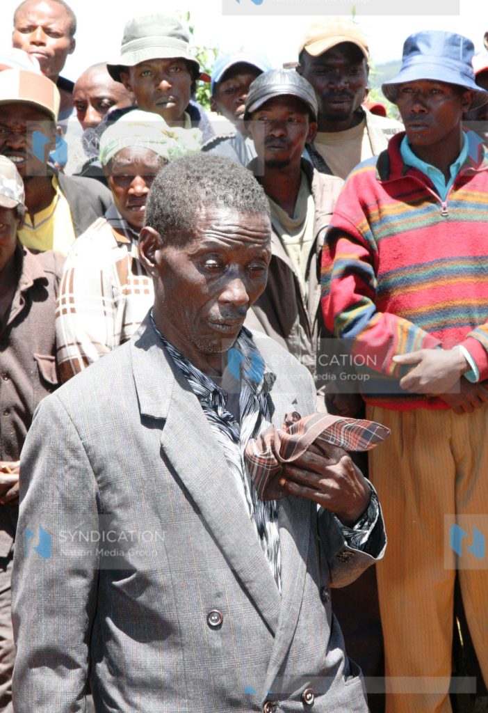 Joseph Mwangi Macharia, 72, in a somber mood during the exhumation of seven bodies of his family members who were killed during post-election violence