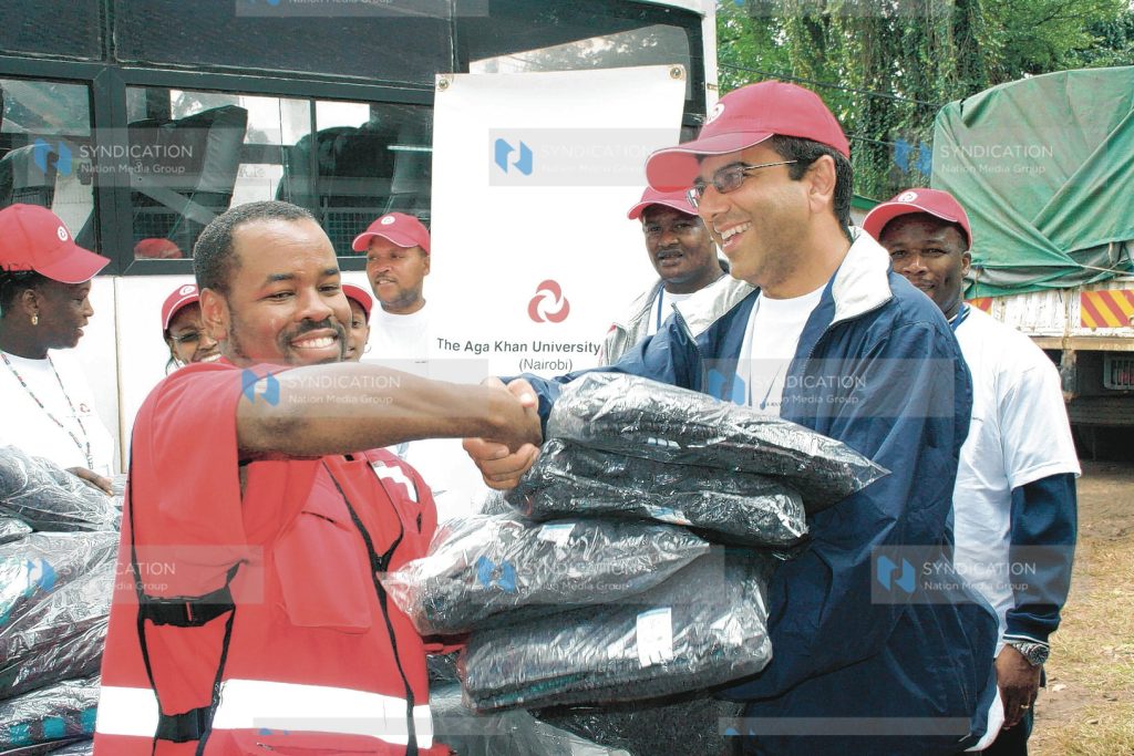 Chief Operating manager The Aga Khan University hospital Moyez Jadavji presents blankets to Red Cross official