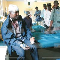 Samson Odhiambo nurses his wounds afflicted on him in the on-going post-election violence
