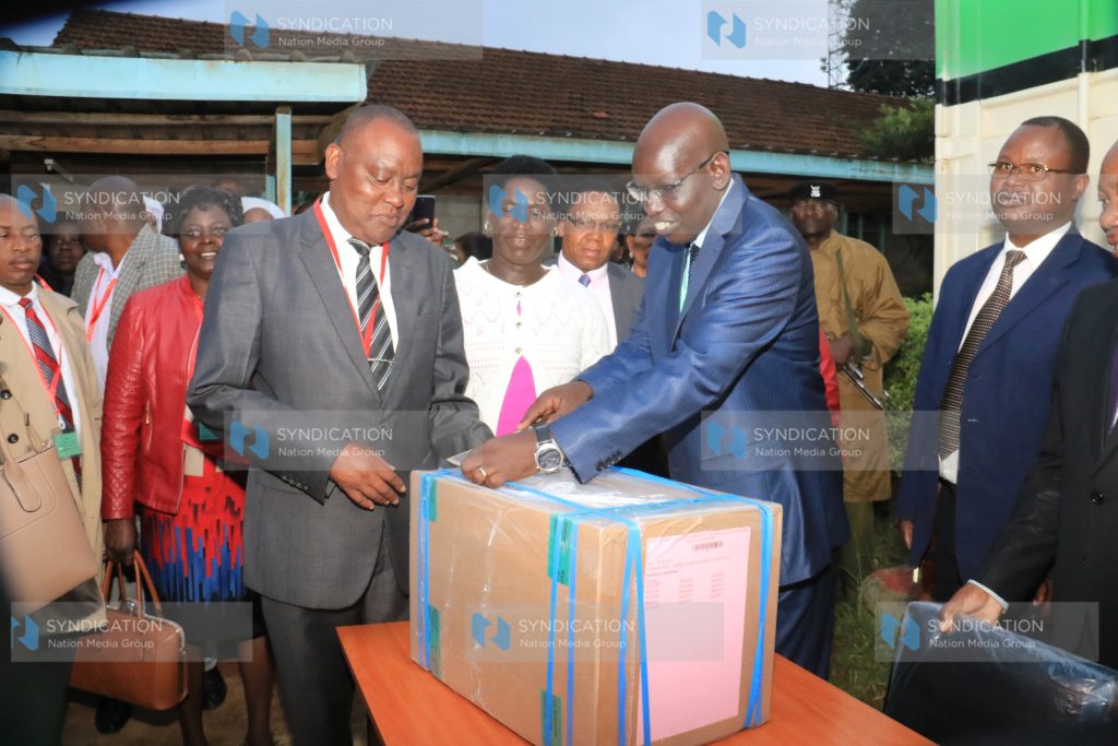 Education PS Belio Kipsang, supervises the distribution of KCPE examination