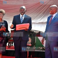 Basic Education PS Belio Kipsang holds up copies of the 2022 KCSE exam results