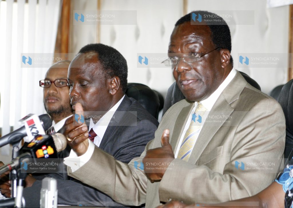 Wycliffe Oparanya, flanked by his Permanent Secretary Edward Sambili (centre)