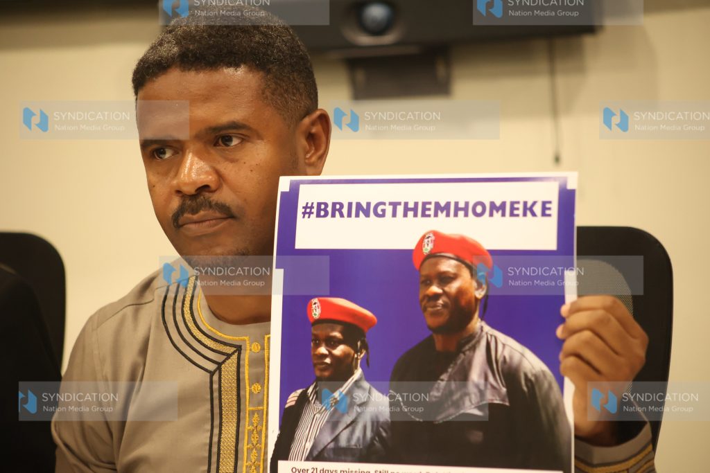 Vocal Africa Executive Director Hussein Khalid displaying a poster