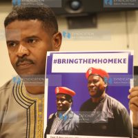 Vocal Africa Executive Director Hussein Khalid displaying a poster